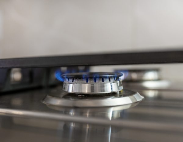 Kitchen gas stove burner with blue flame transparent. Economic crisis, cost of gas rising.
