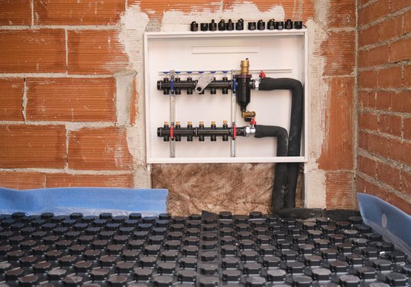 Radiant underfloor heating hydronic manifold instalation.